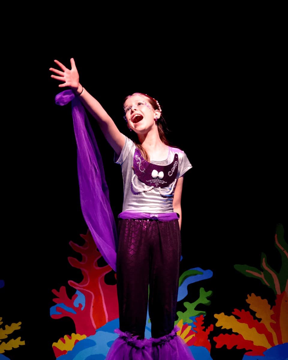 A voice coach working with a young singer at the Smyrna studio
